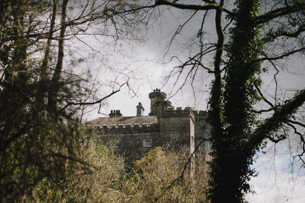 Historical Slane Castle view from the woods while walking on the path on a cloudy day