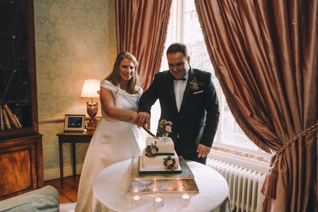 couple cutting wedding cake at tankardstown house meath